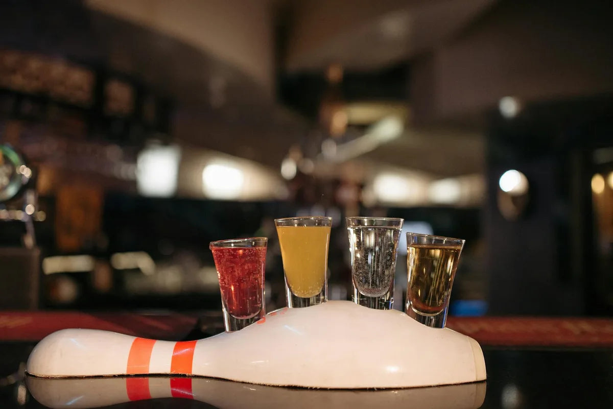 Cocktail glasses lined up at a bar, 1950s atmosphere