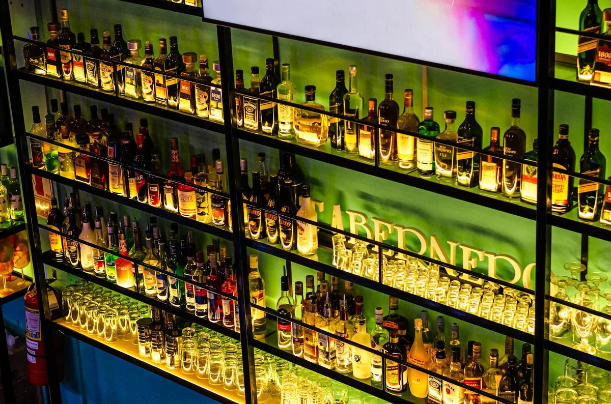 Bottles of spirits on a lit shelf