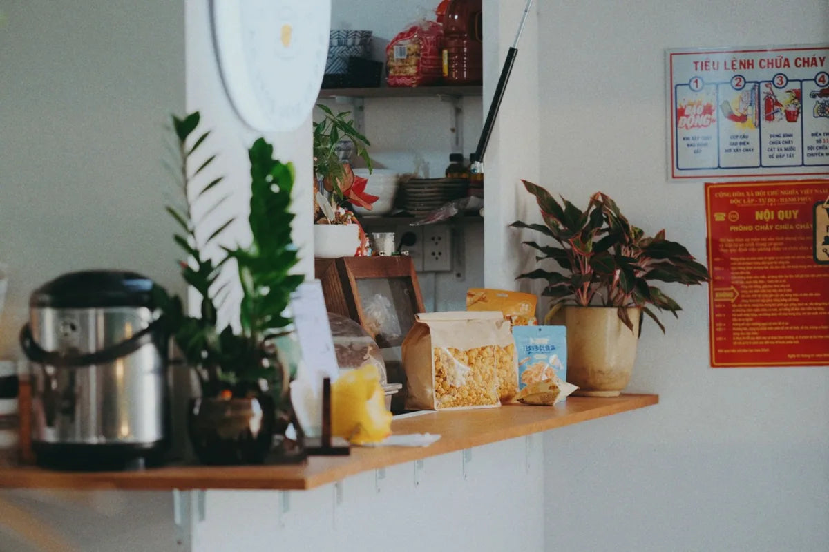 Kitchen shelf with plants and small-format frames