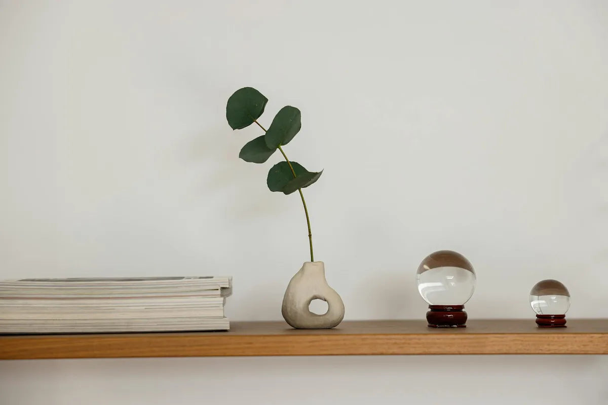 Japandi shelf with a few carefully chosen objects, wood and ceramics