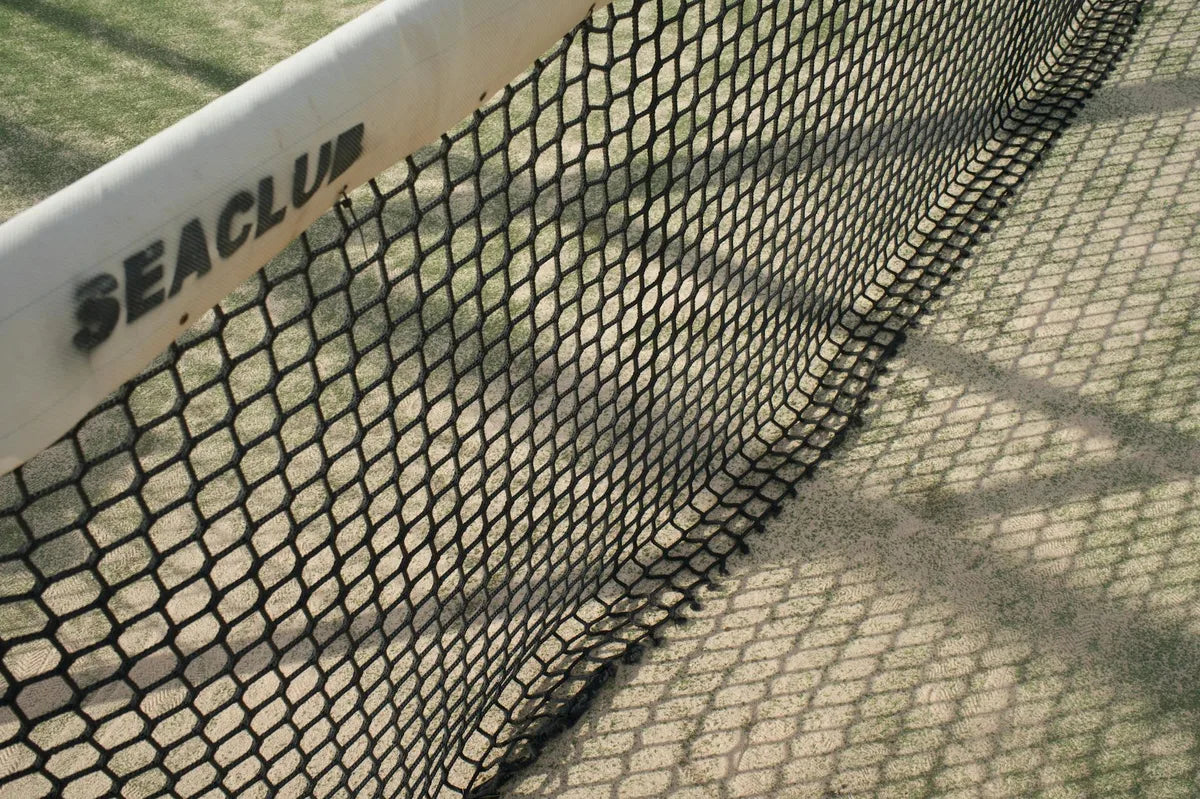 Tennis court on grass, shadow of the stands
