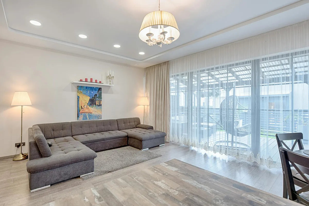 Large poster above a sofa, bright room
