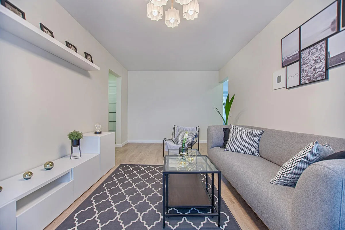 Minimalist living room with a large poster above the sofa