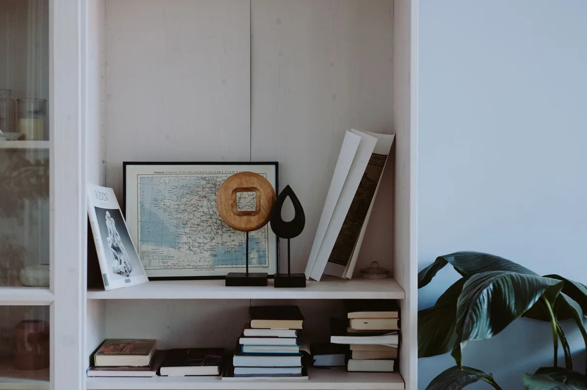 Office shelf with a few books and a small framed piece