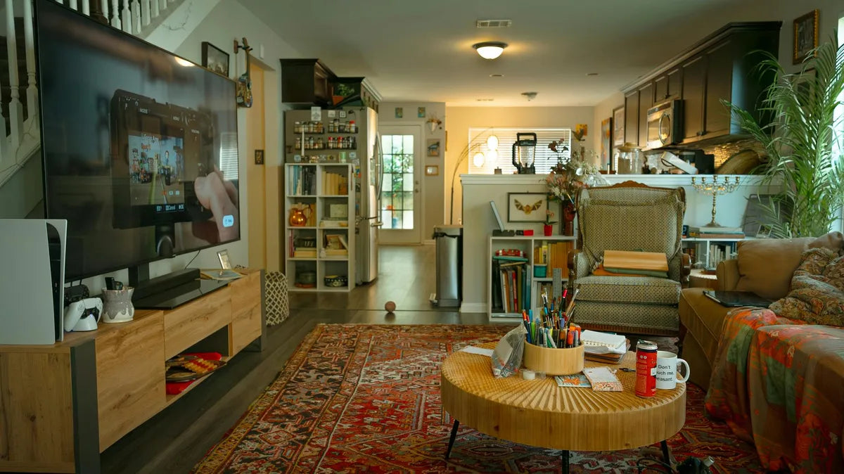 Bohemian living room with Persian rug, bookcase, mixed frames