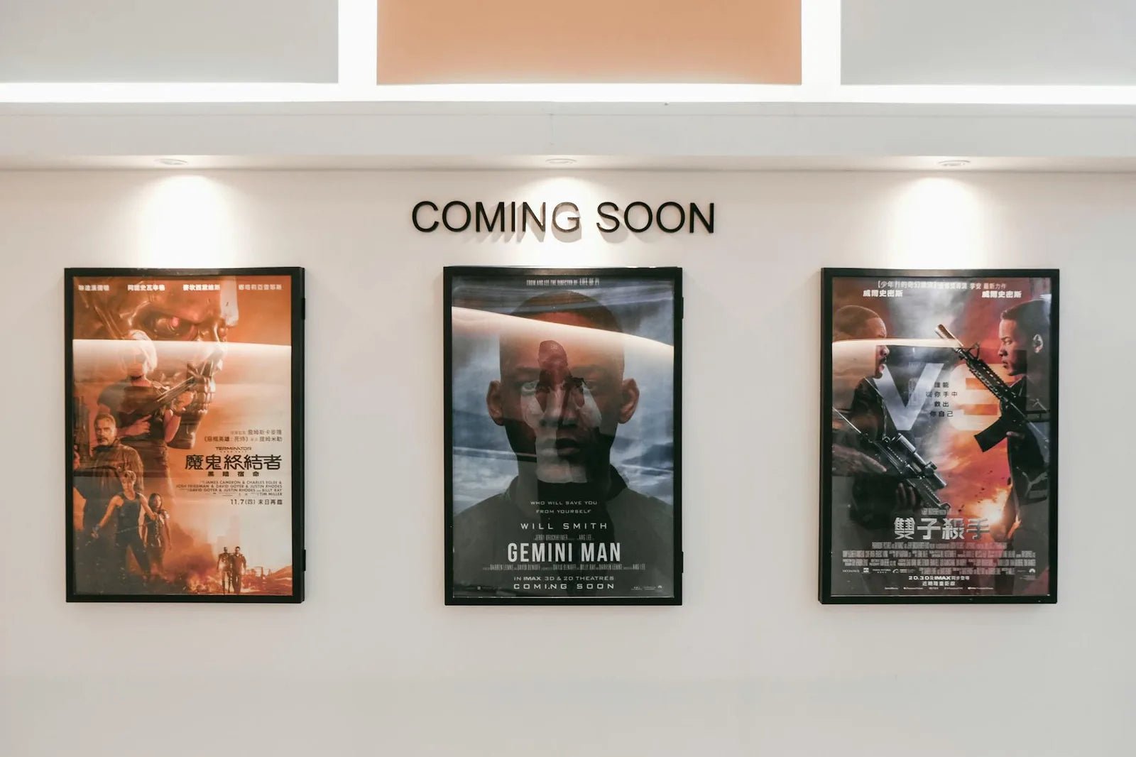 Three framed posters side by side, coherent blue and ochre palette