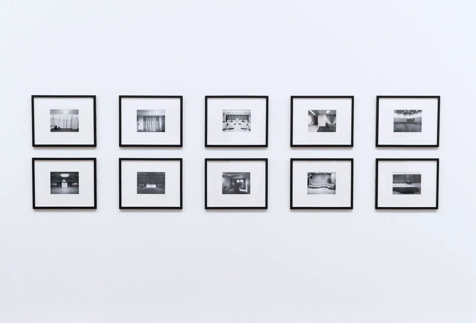 Three different frames leaning against a white wall, oak black white