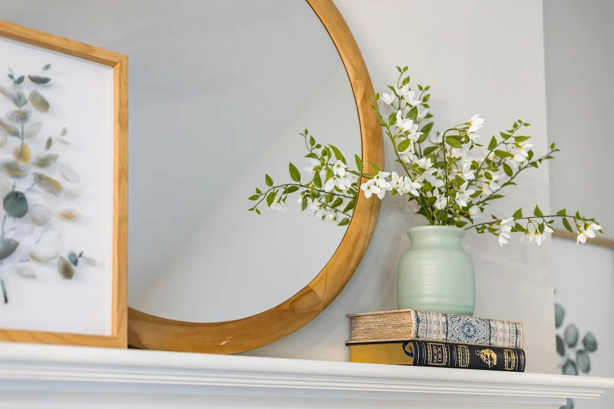 Living room with oak frame and botanical poster on a white wall