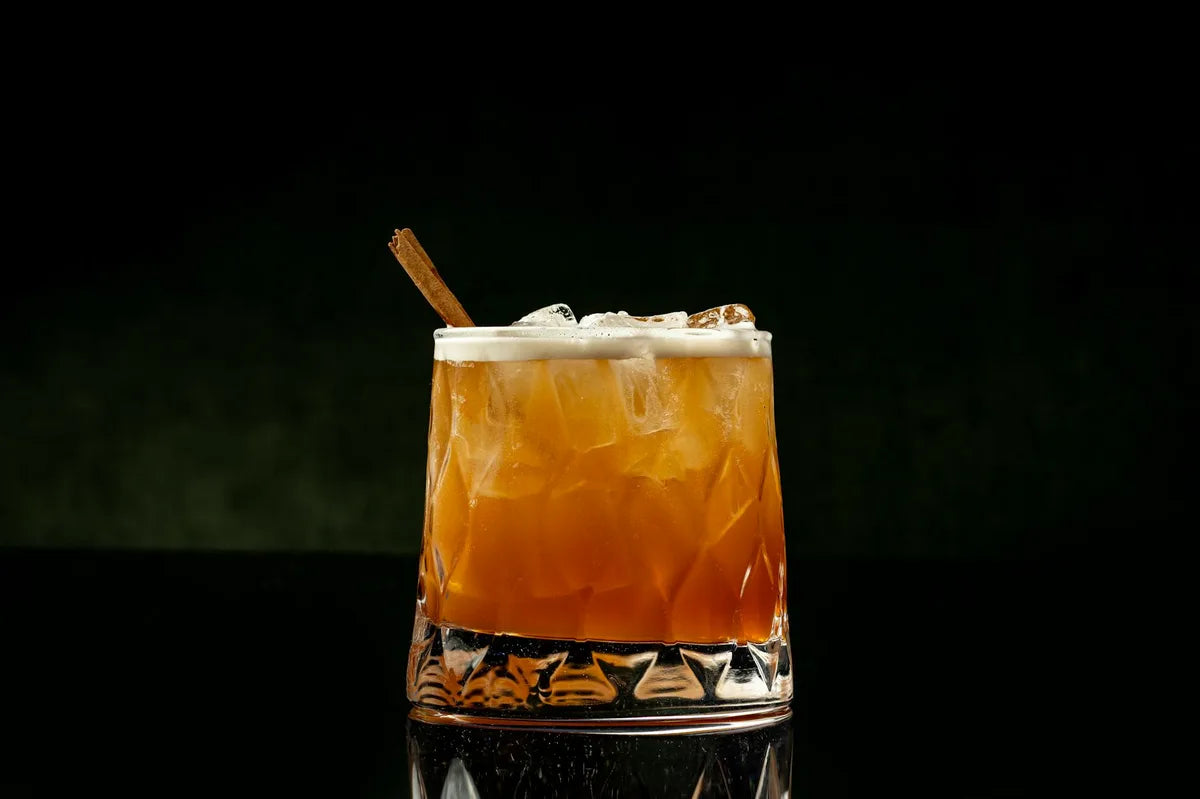 Reddish-orange cocktail glass painted in watercolor, soft beige ground